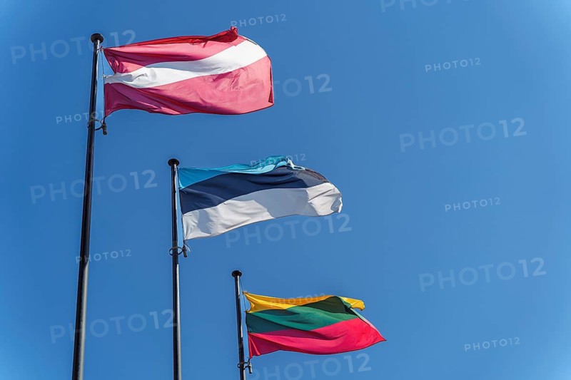 The flags of the three Baltic countries, Lithuania, Latvia and Estonia flutter against a clear blue sky, Flags of Latvia, Estonia, and Lithuania waving against a clear blue sky