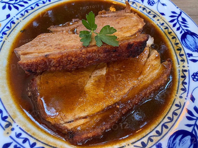 Old Bavarian Munich pork roast with crust, dark beer sauce, on plate, food, Munich, Bavaria, Germany