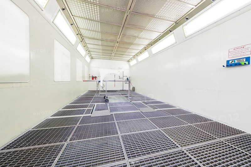 Empty painting booth with bright light and mesh floor, sterile industrial environment, painter, Calw, Germany