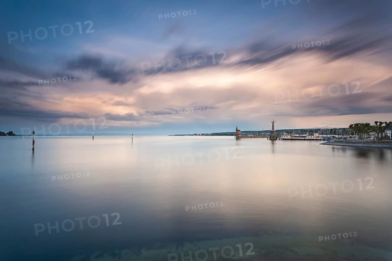 22.05.2022: Passenger ship Konstanz docked by the Imperia statue and historic gauge house under dramatic storm clouds, Constance, Baden-Wuerttemberg, Germany