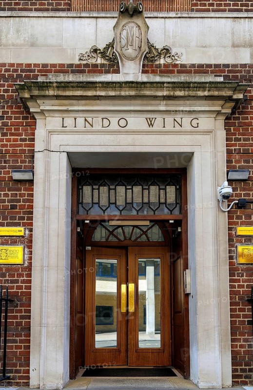 The brown wooden doors and stone surround of the Lindo Wing entrance at St Mary's Hospital mark the private maternity wing opened in 1937 with a donation from businessman Frank Charles Lindo, a location long associated with royal births, London, England, United Kingdom