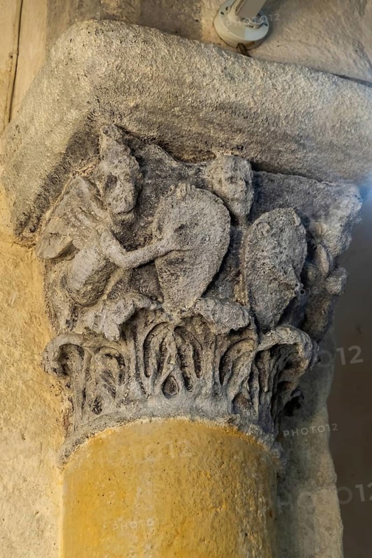 Capital of romanesque church of Saint Nectaire, Victorias with shields, Puy de Dome, Auvergne Rhone Alpes, France