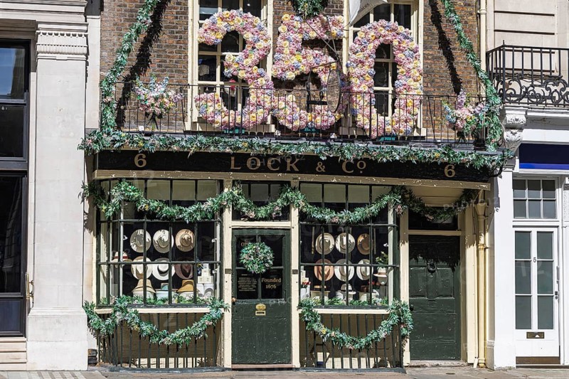 A giant floral 350 marks Lock and Co Hatters' anniversary above its shopfront on St James's Street, London, England, United Kingdom