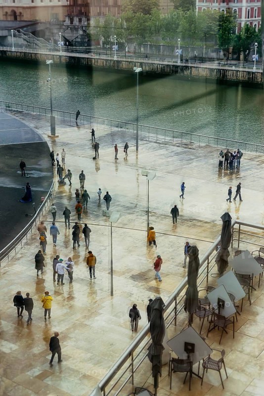 View of a crowd of people with window reflection and movement