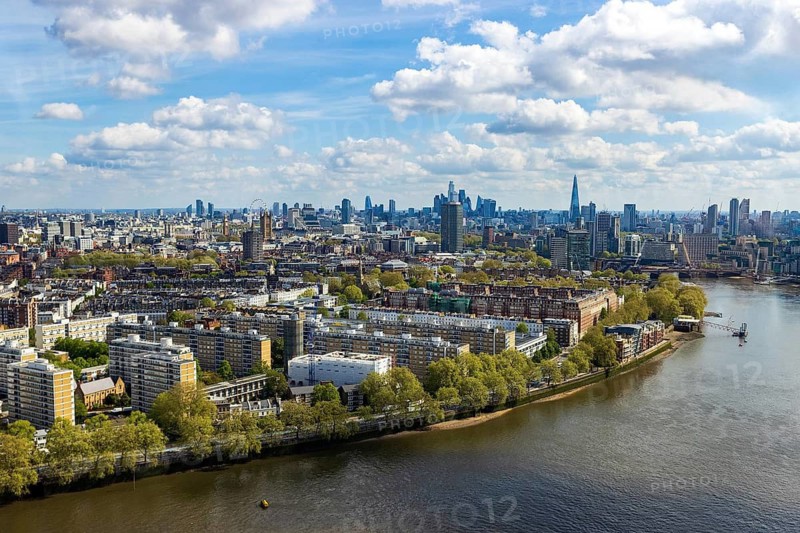 The River Thames curves toward the Shard and City skyline in this aerial view from Battersea Power Station's chimney, London, England, United Kingdom