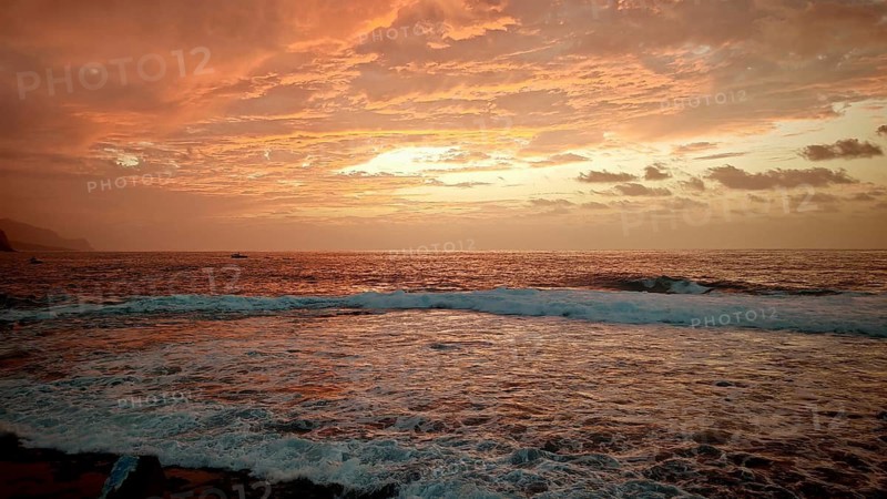 Dramatic sunset over the sea with intense shades of orange and red, Santo Antao, Cabo Verde, Cape Verde Islands