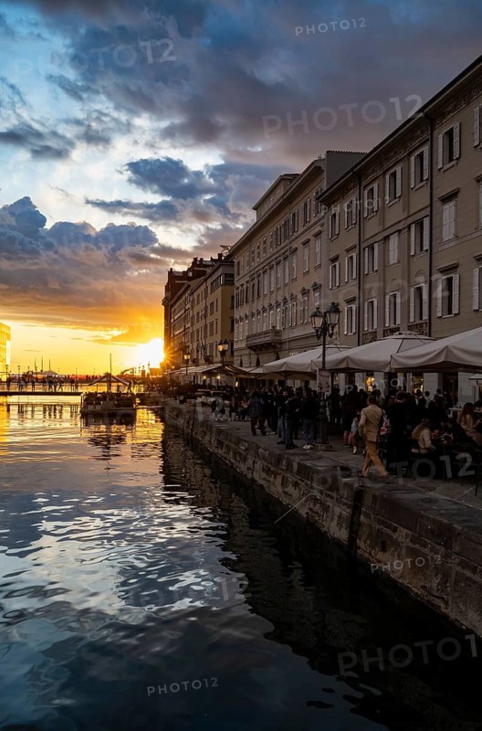 Grand Canal with restaurants, reflection in the canal, sunlight, evening light at sunset, dramatic clouds and atmospheric lighting, Borgo Teresiano, Trieste, Friuli-Venezia Giulia region, Italy