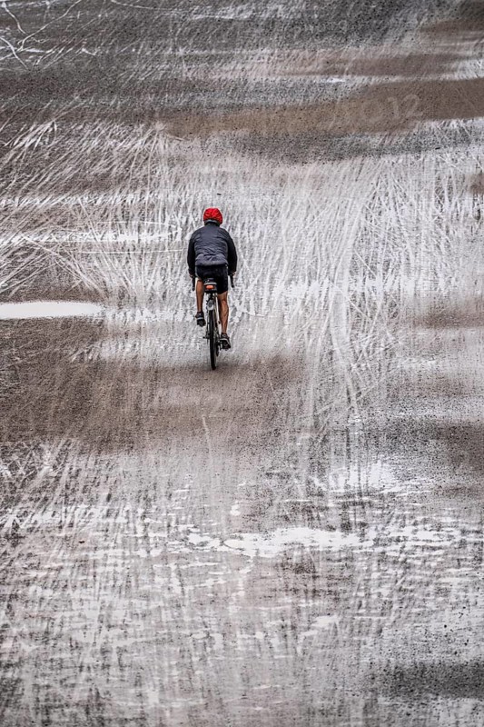 Dirt road, with many tracks of two-wheelers, footprints, cyclists, wet, after rain, parallel, mixed up