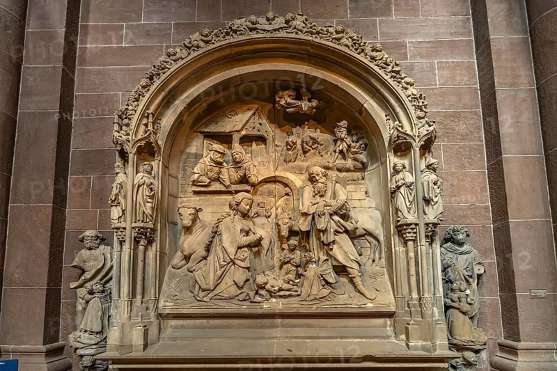 Stone relief of the Nativity in the interior of St. Peter's Cathedral in Worms, Rhineland-Palatinate, Germany
