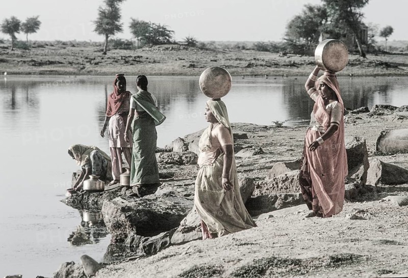 Women carry stuffed water balls on their heads at Gadsisar Lake, Jaisalmer, Rajastan, India