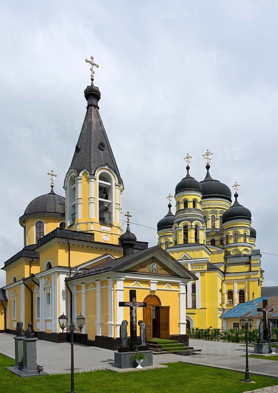 Orthodox church with yellow façade and black domes under cloudy sky, Hîncu monastery, Hâncu, Hâncul, Hincu, Hancu, Hancul, located near the village of Bursuc, Nisporeni district, Republic of Moldova, Moldova