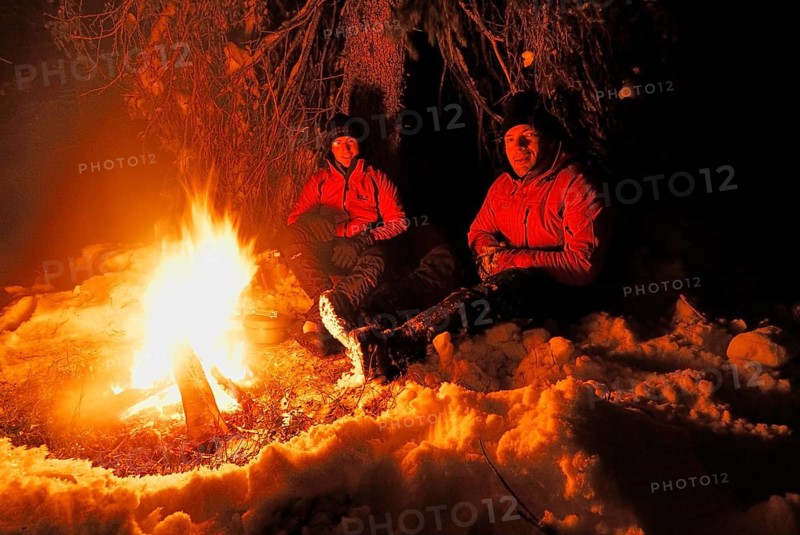 Two men around a campfire at night, Muddus National Park, Laponia World Heritage Site, Lapland, Norrbotten, Sweden, Scandinavia, Europe Scandinavia