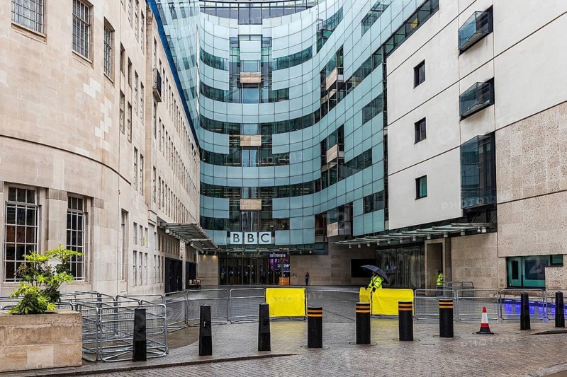 Contrasting glass and Portland stone wings meet at the entrance of BBC Broadcasting House, London, England, United Kingdom