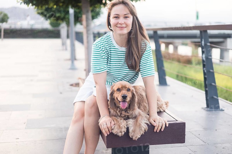 Relaxed moment showcasing companionship between a woman and her dog on a bench