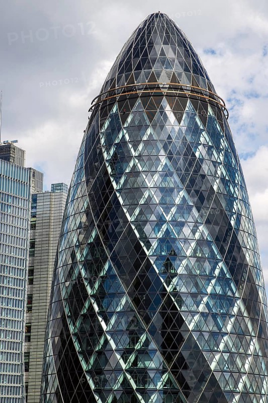 Norman Foster's lattice glass tower at 30 St Mary Axe, nicknamed The Gherkin, rises above the City of London, England, United Kingdom