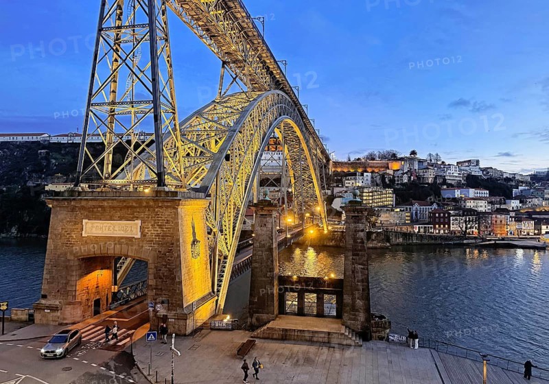 Illuminated arch bridge Ponte Dom Luis I designed by Théophile Seyrig, looking towards Vila Nova de Gaia in the evening, Porto, Portugal