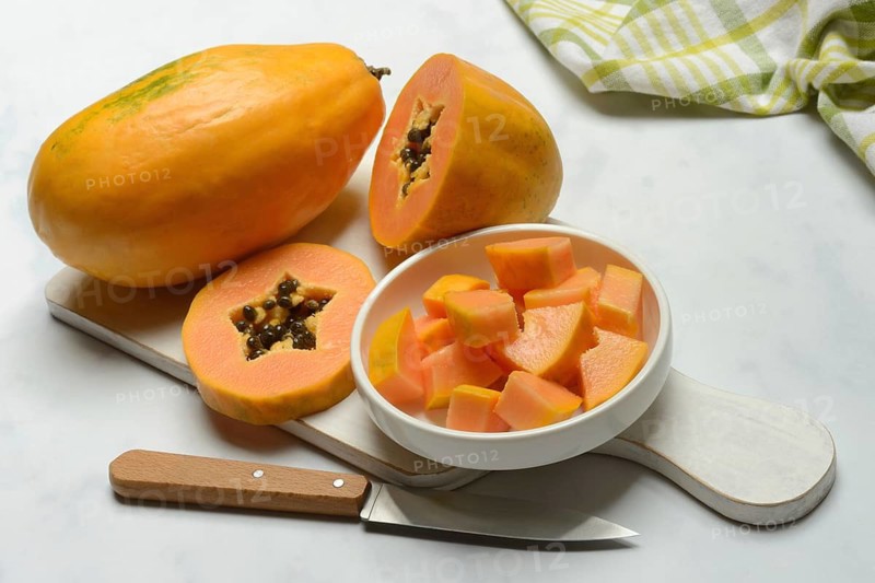 Pawpaw, split fruit in skin, halved and whole fruit, Carica papaya