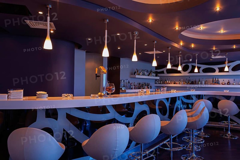 Contemporary bar with stylish lighting and elegant seating in a nighttime setting, Cyprus
