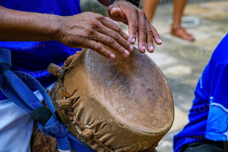 Drummer playing a rustic and rudimentary atabaque during tambor de crioula cultural manifestation, Sao Luis, Maranhao, Brazil