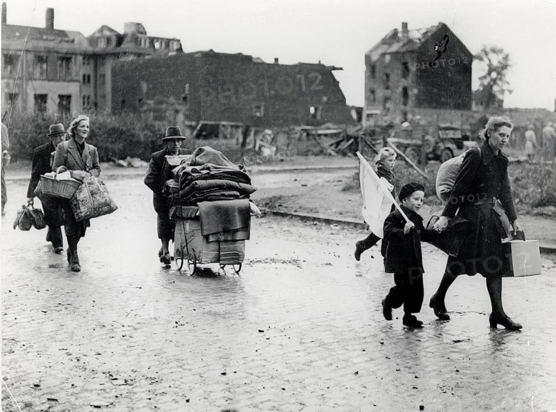 Flight, Germany, end of war, children with white flag, World War II, eastern regions, National Socialism, poverty, poverty, a group of refugees, including woman and children, moving with luggage on a wet road, 1945