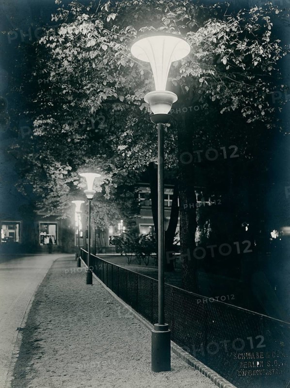 Berlin, zoological garden, garden restaurant, modern lighting, destroyed during war, romantic evening atmosphere along an illuminated walkway under trees with street lamps, Schwabe Co., 1928