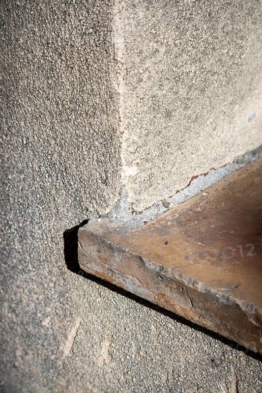 A terracotta tile covers the edge of a low doorstep beside a rough stucco wall at the base of a doorway, Saint-Tropez, Var, Provence-Alpes-Cote d'Azur, France
