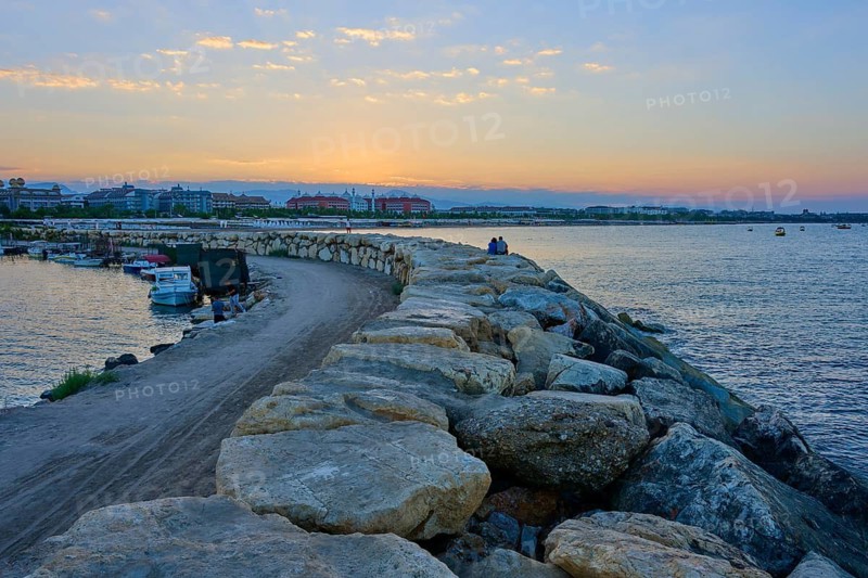 Rocky coast overlooking the sea and a golden sunrise, marina, Evrenseki, Manavgat, Antalya, Turkish Riviera, Mediterranean Sea, Turkey