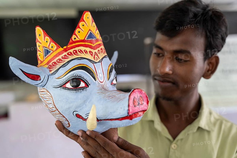 A student holds a traditional mask he created, in a traditional mask-making workshop during an internship programme at J.D.S.G. College on Wednesday 8 July 2026 at Bokakhat, in Golaghat district of Assam. Under the guidance of artisan Khagen Goswami from Sukumar Kala Peeth, Majuli, participants are trained in the traditional mask-making techniques of Majuli's centuries-old Sattriya cultural heritage