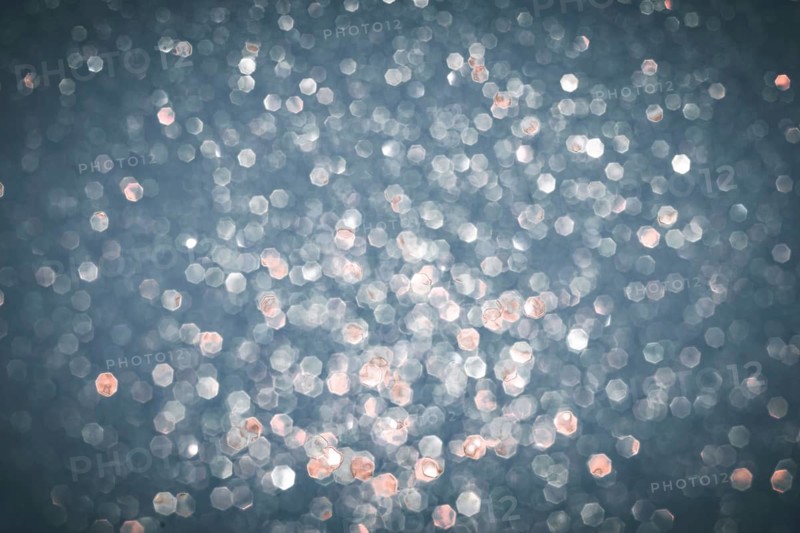 Abstract glitter lights textured silver, gray and white colored background, de-focused, bokeh. Christmas or New Year festive blured sparkling background, winter holidays card concept