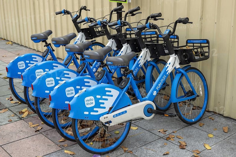 A series of Hello PunPun rental bikes, the blue and white wheels are properly available and show the modern, app-based bike sharing in the historic city center, station in the Phra Nakhon district, Bangkok, Thailand