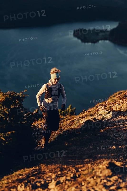 Trail running in autumn on the Jochberg on Lake Walchensee against the wonderful backdrop of the Alps, Bavaria, Germany
