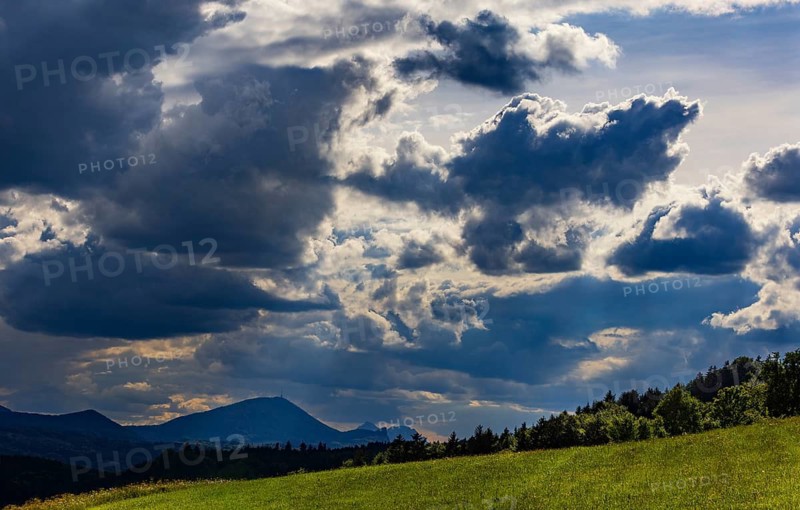 Meadow with dramatic cloudy sky, agricultural landscape, Mondseeland, Salzkammergut, Austria