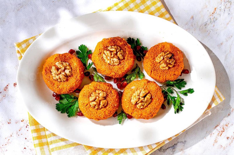 Pumpkin phali, Georgian dish, on a white plate, pumpkin appetizer with nuts and spices, no people, homemade