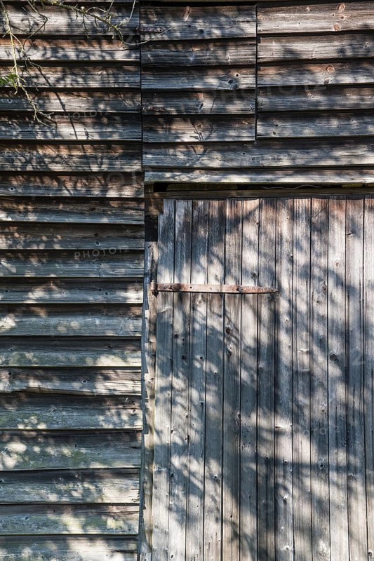 Wooden hut with shadows from trees, Germany