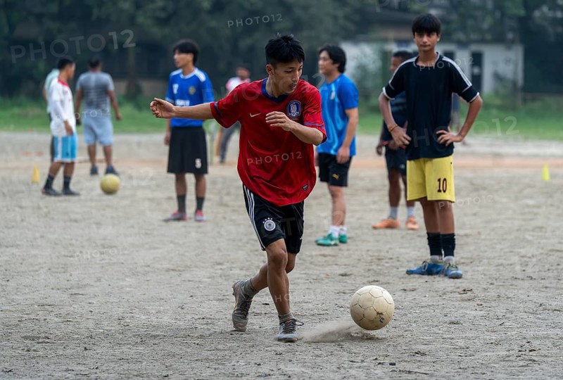 Children play football on a dusty neighbourhood field, chasing the ball with energy and determination, as the FIFA spotlight captivates fans around the world, in Guwahati, India on 27 June 2026
