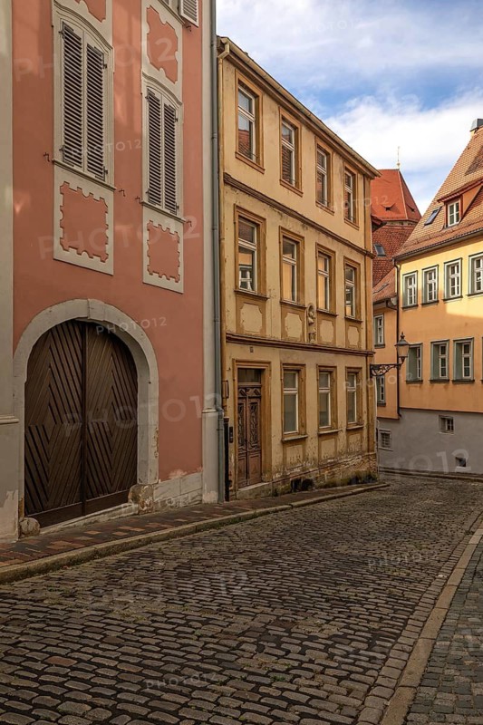 20 August 2026, historic buildings and cobblestone street along Eisgrube lane in the old town of Bamberg, Bavaria, Germany