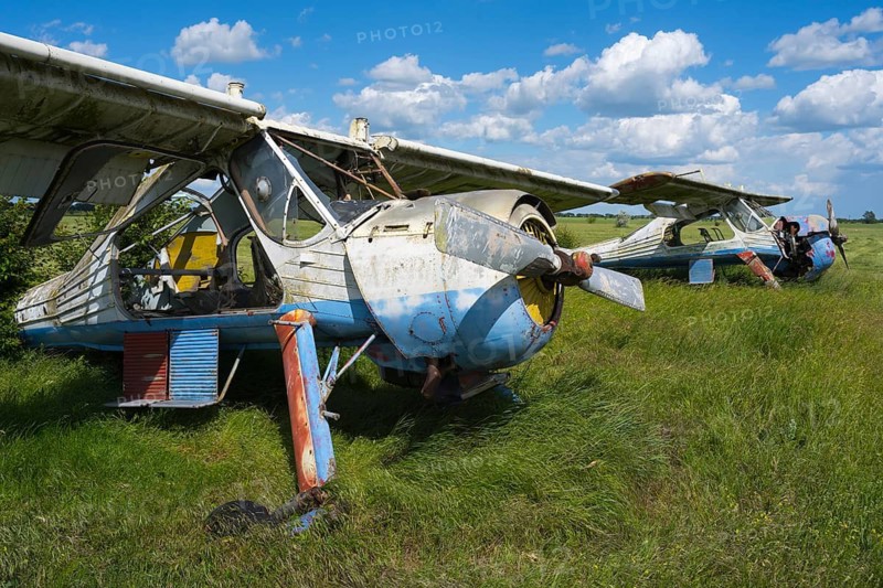 Two weathered, rusted aircraft are next to each other on a green field, PZL-104 Wilga multi-purpose aircraft, abandoned airport, Ceadir-Lunga, Ceadîr-Lunga, Chadyr-Lunga, Taraclia district, Gagauzia autonomous region, Republic of Moldova, Moldova