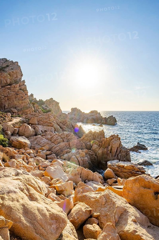 Landscape of the coastline with blue water at Costa Paradiso on a sunny day at evening, Sardinia, Italy