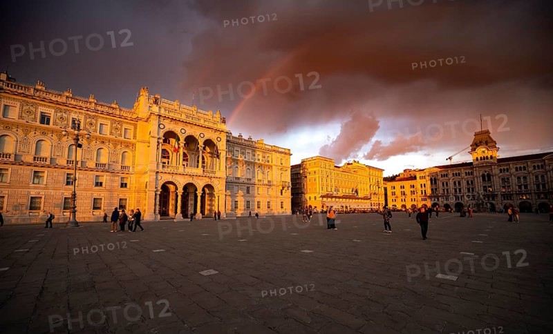 Town Hall and Palazzo Stratti and Palazzo della Luogotenenza Austriaca or Palazzo Governo in the evening light at sunset with rainbow, Piazza Unità d'Italia square, dramatic clouds, old town, Trieste, Friuli-Venezia Giulia region, Italy