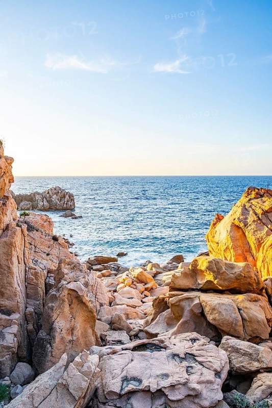 Landscape of the coastline with blue water at Costa Paradiso on a sunny day at evening, Sardinia, Italy
