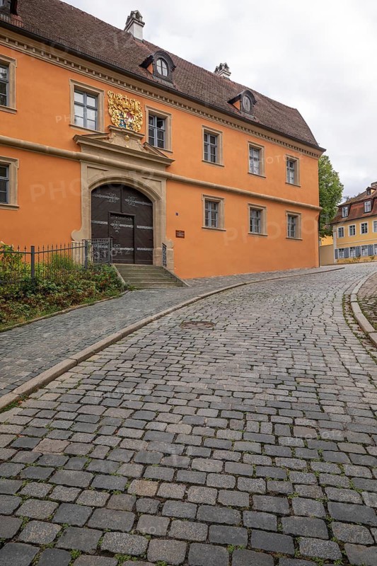 20 August 2026, Exterior view of the historic Haus zur Goldenen Wappe along a cobbled street in Bamberg, Bavaria, Germany