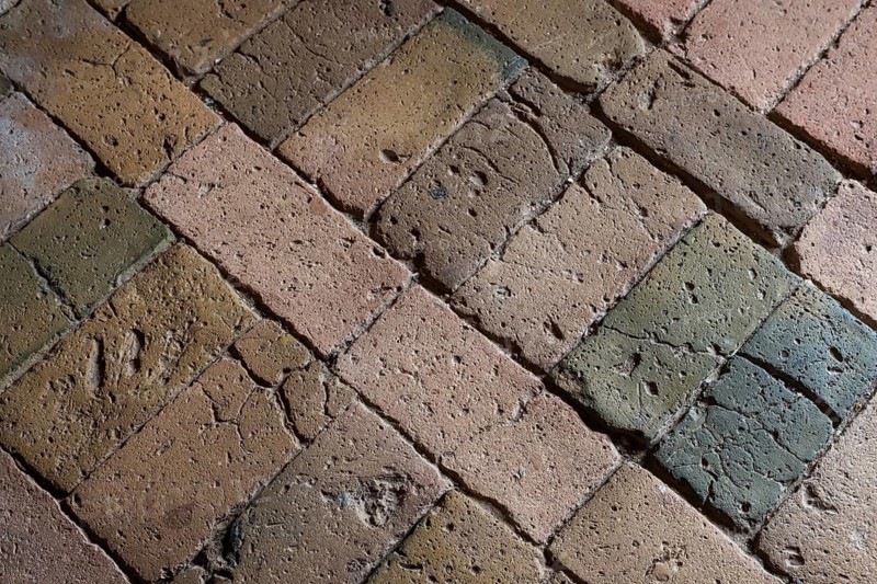 Detailed view, floor with old earth-colored bricks crisscrossed by cracks, church, Husby Church, Husby, Holstebro Municipality, Denmark