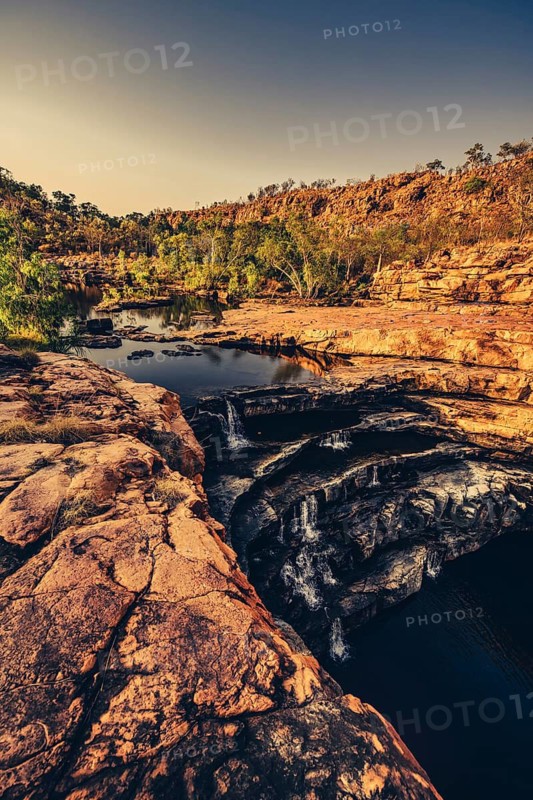 Bell Gorge waterfall, a body of water in north-west Australia in the Kimberley. Sunrise in the outback, Australia