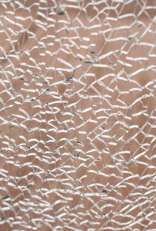 Abstract cracked texture resembling dry soil or drought affected earth. Natural fragmented pattern symbolizing climate change, environmental crisis, heat, dehydration and ecological instability