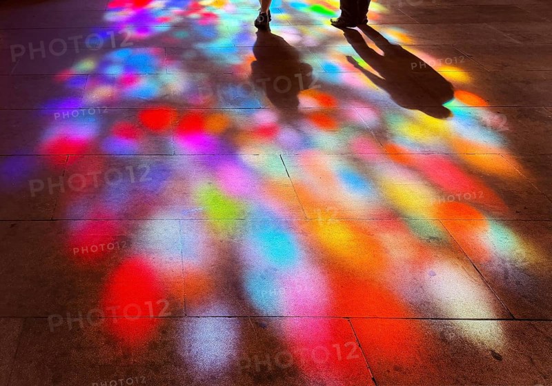 Shadows of two people and colorful spots of light on the floor through the stained glass windows by Alfred Manessier, Church of Our Dear Lady, Bremen, Germany