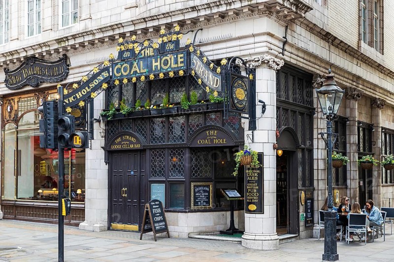 The Coal Hole, a Grade II listed Edwardian pub built by T E Collcutt, stands within Savoy Court on the Strand, London, England, United Kingdom