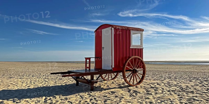 A red bathing cart on the west beach with the sea, North Sea island of Borzburg, East Frisia, Lower Saxony, Germany