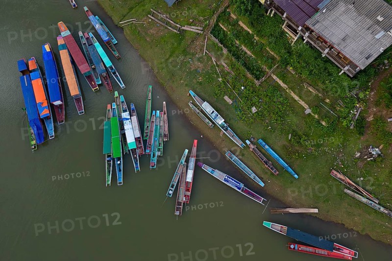 Aerial view, colorful Laotian boats lying on the banks of the Nam Ou River and in the water, Muang Ngoi Neua, Northern Laos, Louangphrabang Province, Laos