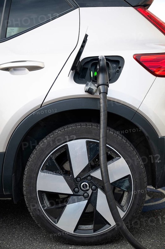 All-electric Volvo is being charged, charging cable in power tank, charging station for electric vehicles, Norway