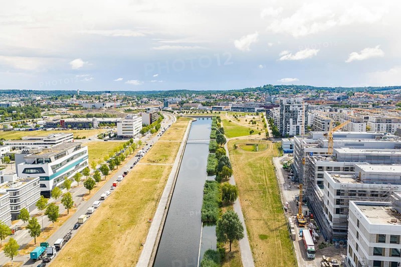 Urban landscape from above with a river, modern buildings and a cloudy sky, new hospital building, Böblingen airfield, Germany
